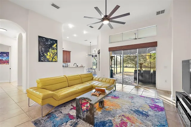 a living room with furniture ceiling fan and a rug