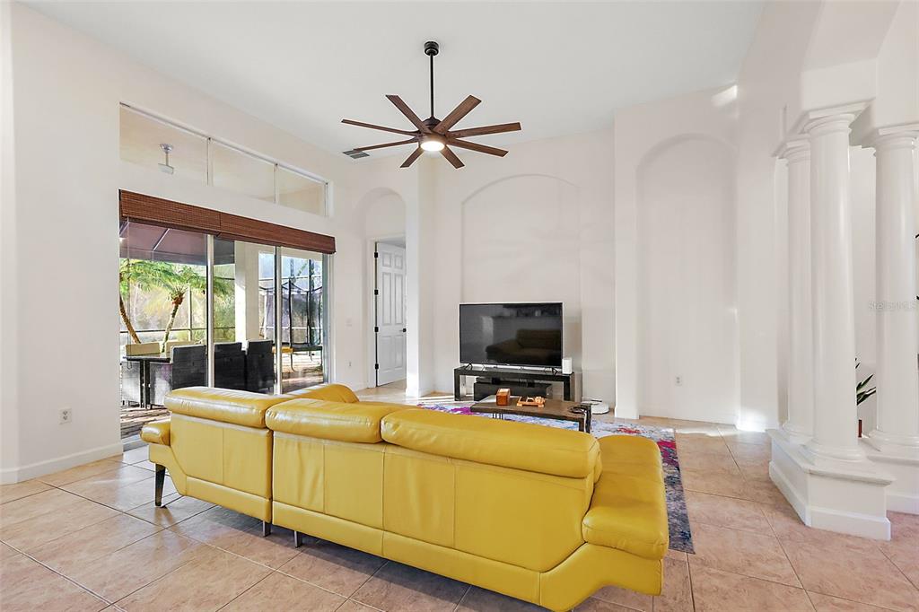9930 Santa Barbara Court Howey-in-the-Hills, FL 34737 - Photo 14 of 44 a living room with furniture and a flat screen tv