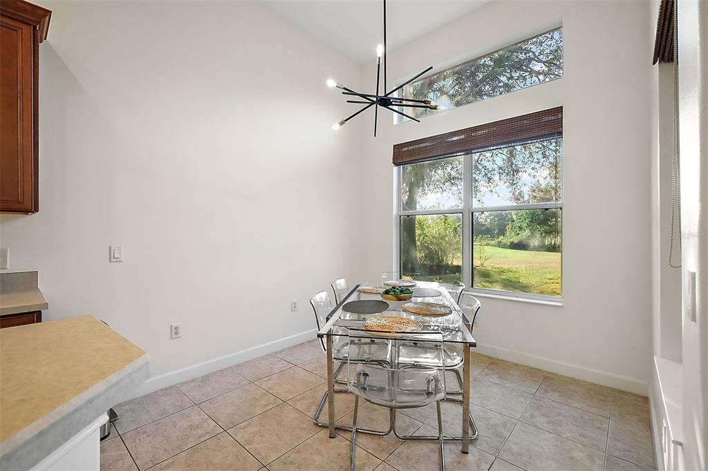 9930 Santa Barbara Court Howey-in-the-Hills, FL 34737 - Photo 18 of 44 a dining room with a window and ceiling fan