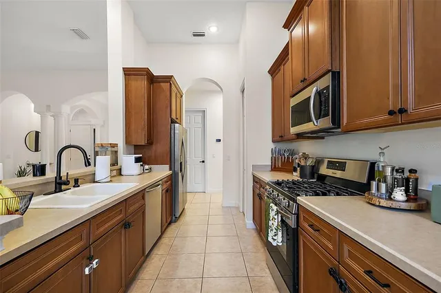 a kitchen with stainless steel appliances granite countertop a sink and cabinets