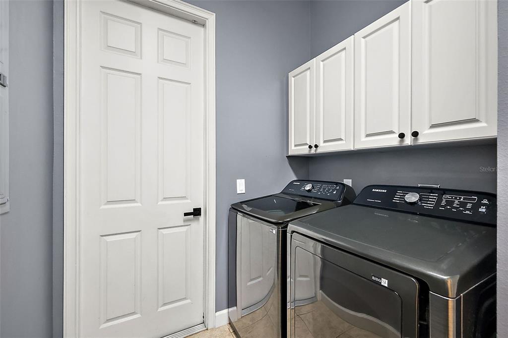 9930 Santa Barbara Court Howey-in-the-Hills, FL 34737 - Photo 23 of 44 a kitchen with a stove and a cabinets