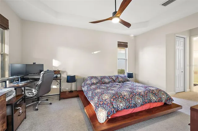 a bedroom with a bed and a desk