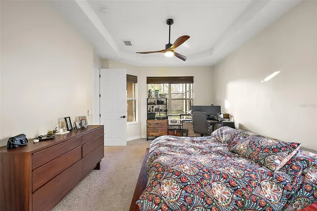 a bed room with a bed and a large window