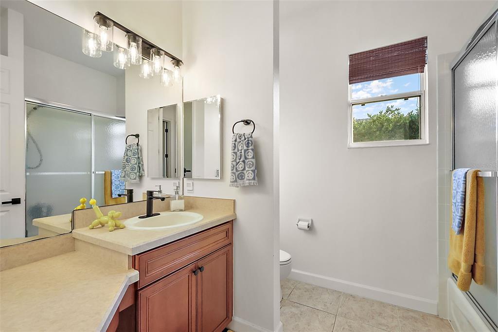 9930 Santa Barbara Court Howey-in-the-Hills, FL 34737 - Photo 30 of 44 a bathroom with a sink and a mirror