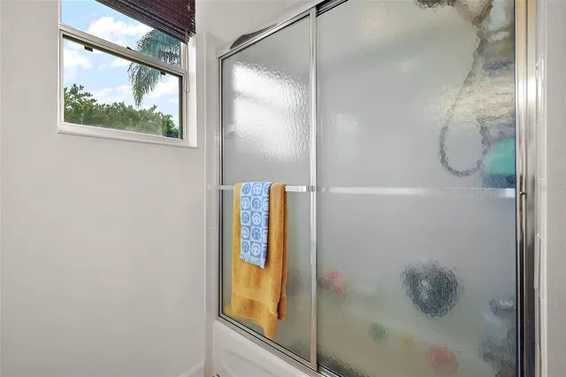 a bathroom with a glass shower door