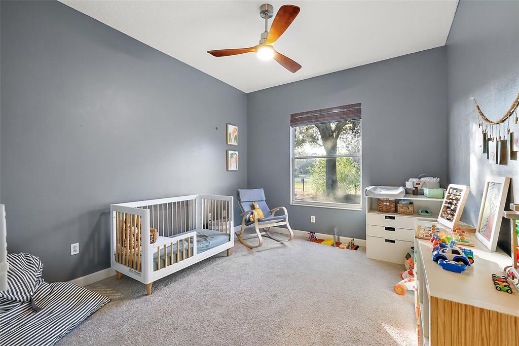9930 Santa Barbara Court Howey-in-the-Hills, FL 34737 - Photo 32 of 44 a bedroom with furniture and a window