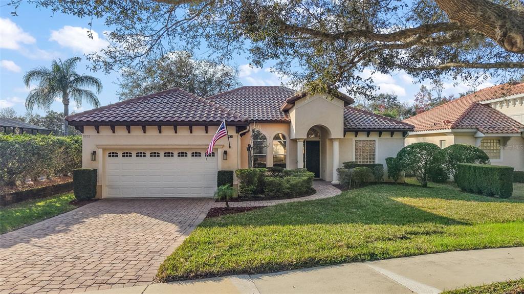 9930 Santa Barbara Court Howey-in-the-Hills, FL 34737 - Photo 33 of 44 a front view of a house with a garden