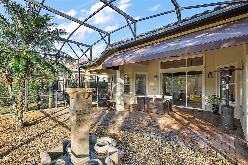 9930 Santa Barbara Court Howey-in-the-Hills, FL 34737 - Photo 34 of 44 a view of a patio with table and chairs and potted plants