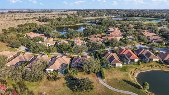 an aerial view of residential houses with outdoor space and swimming pool