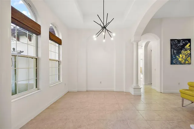 an empty room with windows and cabinet