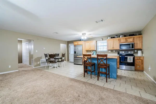 a view of kitchen with microwave and cabinets