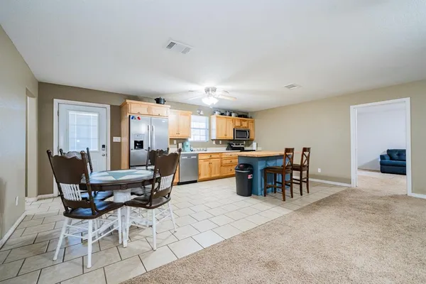a view of a dining room with furniture and a livingroom