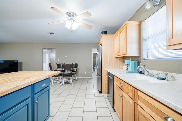 a kitchen with a sink cabinets and window