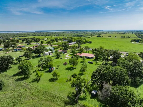 an aerial view of a houses with a yard