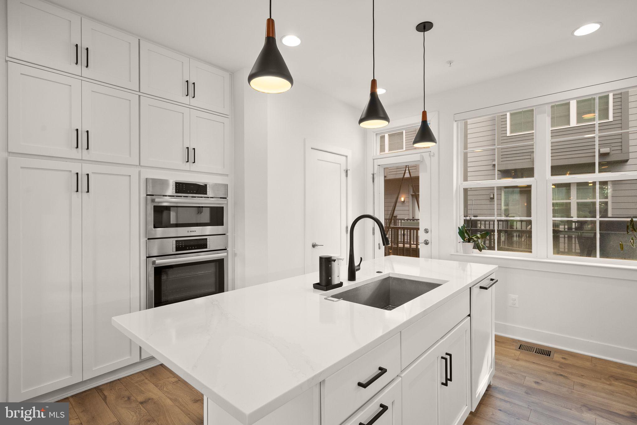11258 Faraday Park Drive Reston, VA 20190 - Photo 13 of 44 a kitchen with stainless steel appliances a sink a stove a refrigerator and cabinets