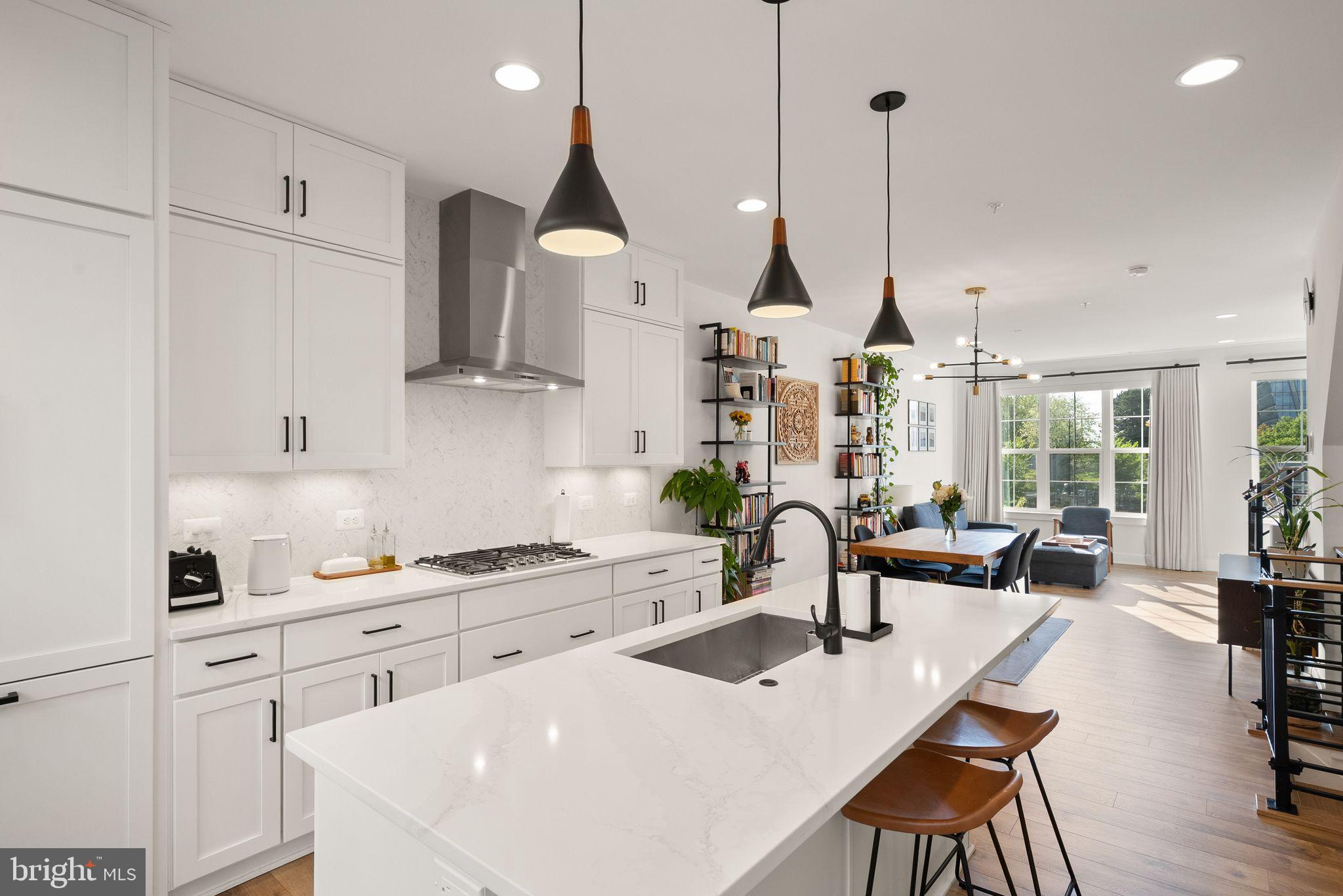 11258 Faraday Park Drive Reston, VA 20190 - Photo 14 of 44 a kitchen with stainless steel appliances granite countertop a sink a stove and a wooden floors