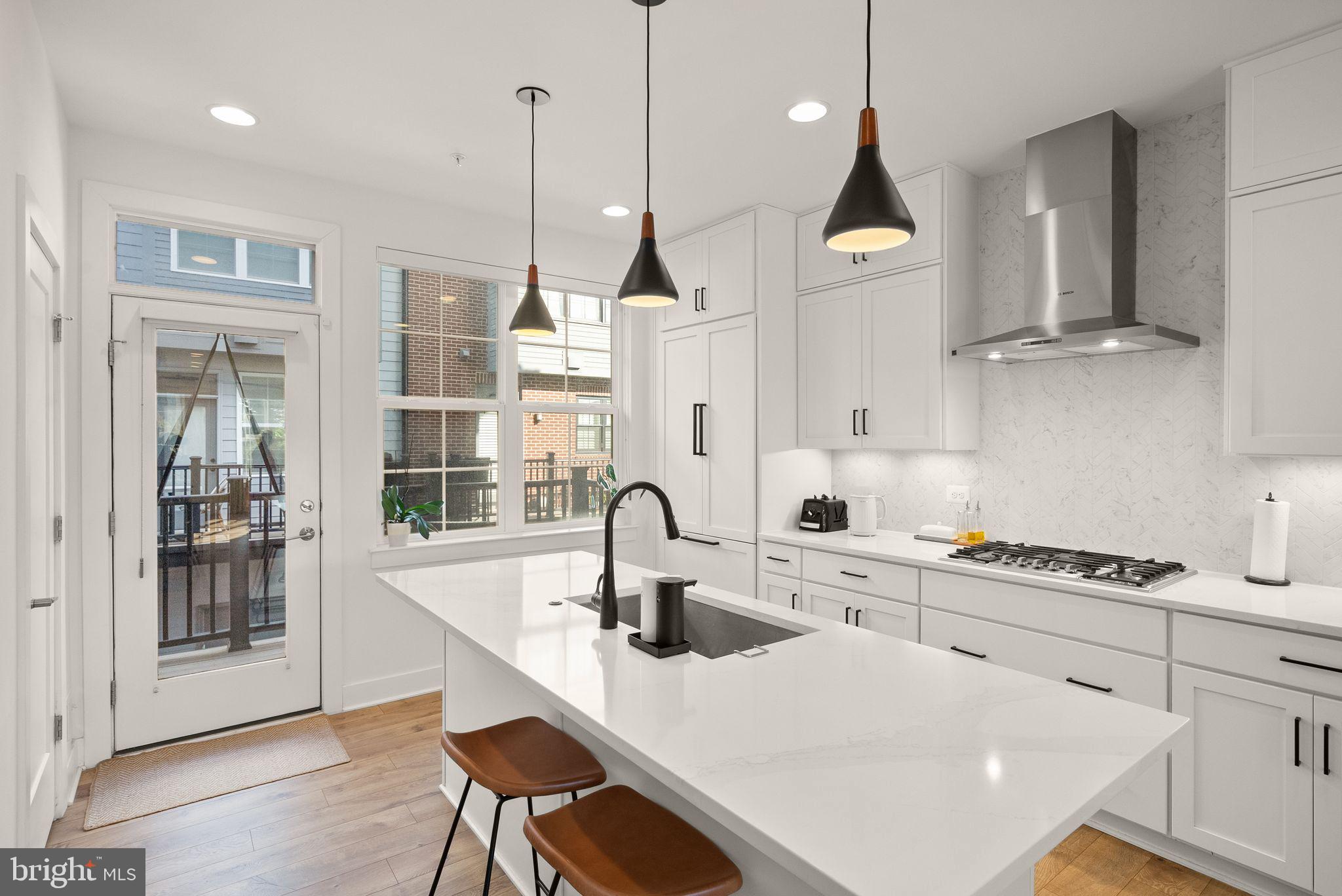 11258 Faraday Park Drive Reston, VA 20190 - Photo 16 of 44 a kitchen with kitchen island a appliances a sink and cabinets