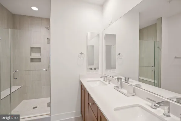 a bathroom with a sink double vanity and shower