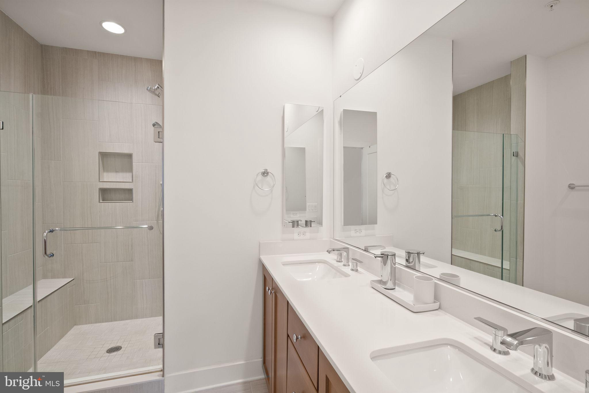 11258 Faraday Park Drive Reston, VA 20190 - Photo 24 of 44 a bathroom with a sink double vanity and shower