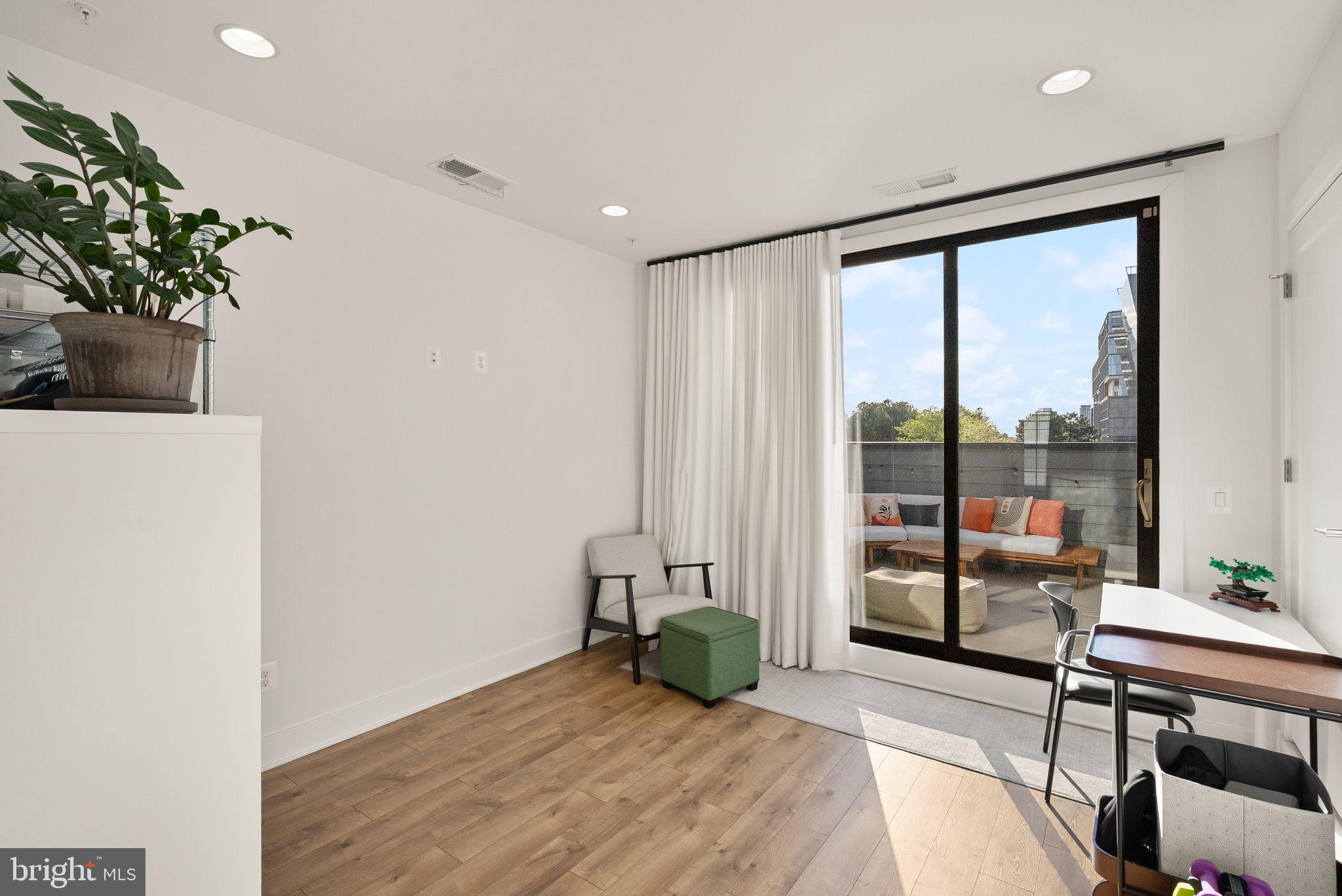 11258 Faraday Park Drive Reston, VA 20190 - Photo 31 of 44 a view of a room with wooden floor and floor to ceiling window