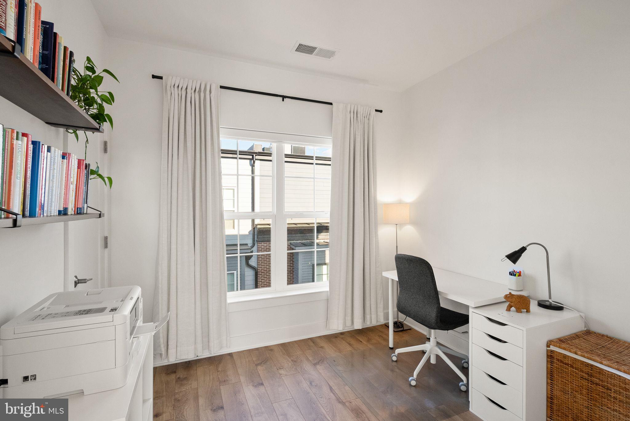 11258 Faraday Park Drive Reston, VA 20190 - Photo 33 of 44 a view of a workspace with furniture and a window