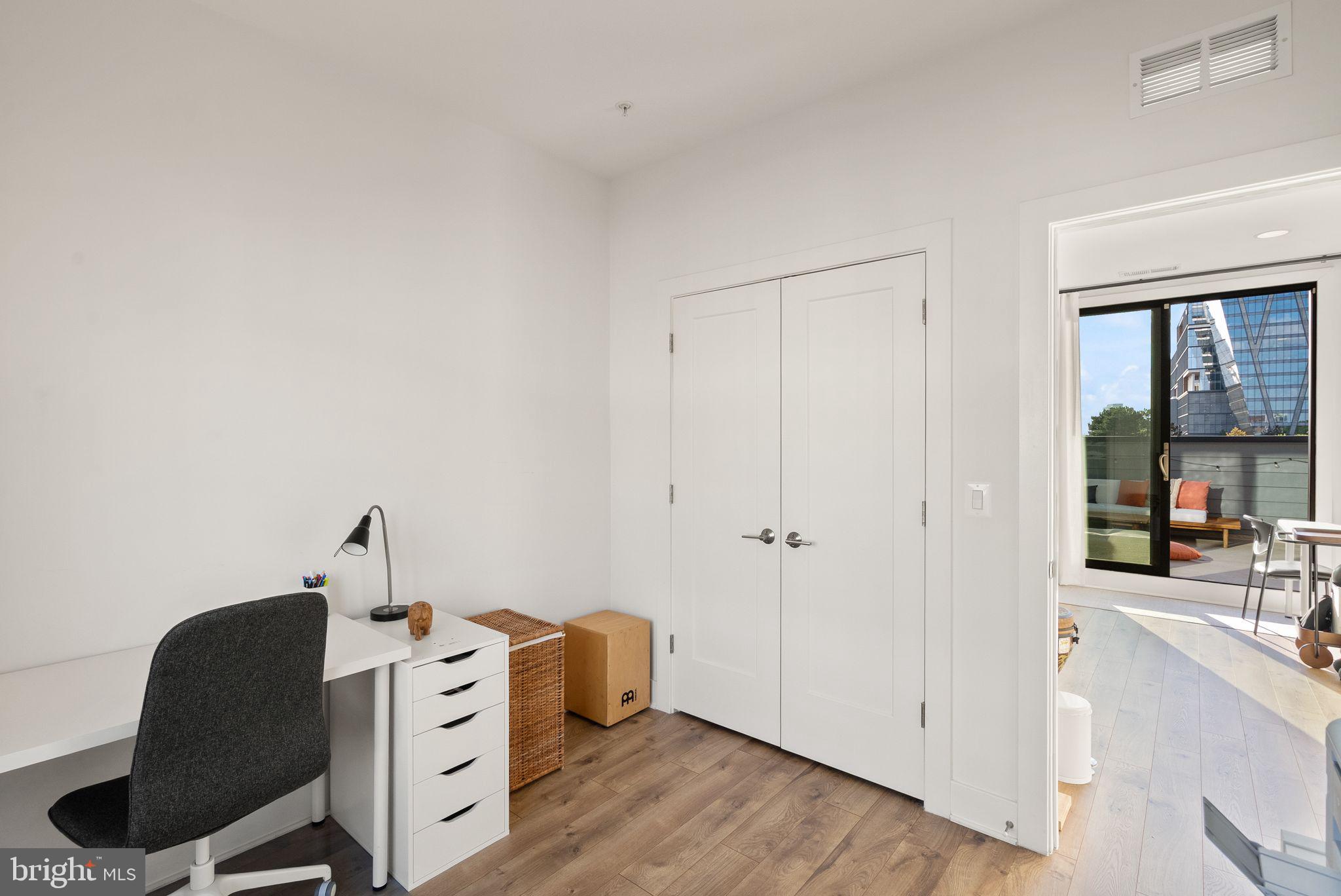 11258 Faraday Park Drive Reston, VA 20190 - Photo 34 of 44 a view of workspace with wooden floor windows cabinet and glass door