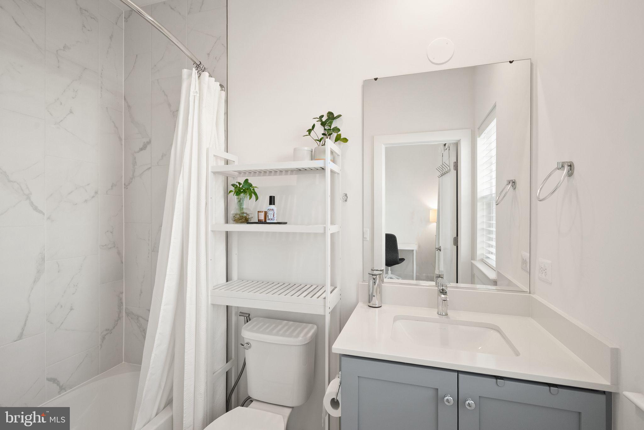 11258 Faraday Park Drive Reston, VA 20190 - Photo 36 of 44 a bathroom with a sink and a mirror