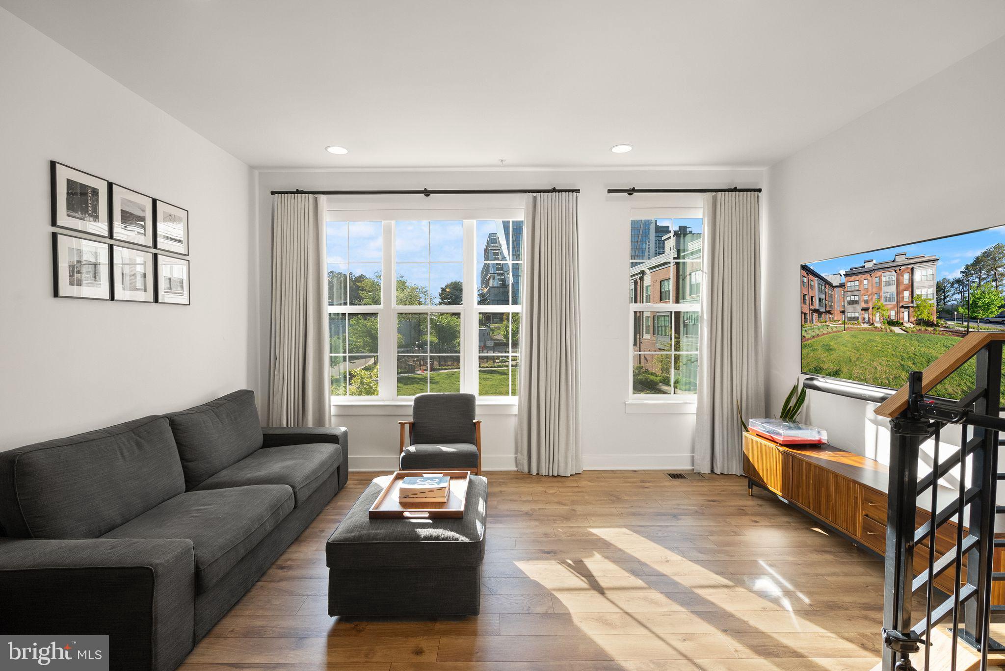 11258 Faraday Park Drive Reston, VA 20190 - Photo 5 of 44 a living room with furniture and a flat screen tv