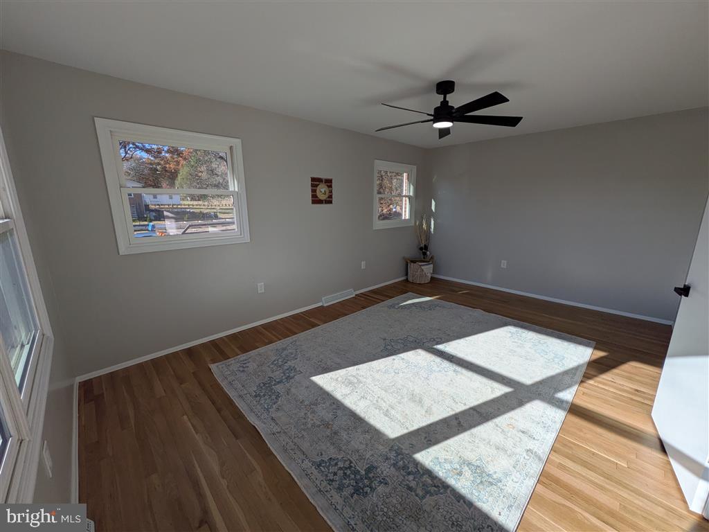 7183 Oak Drive Reva, VA 22735 - Photo 4 of 6 a view of an empty room with wooden floor and a ceiling fan