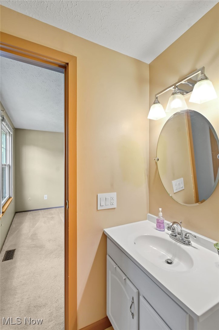 2610 Norton Road Stow, OH 44224 - Photo 23 of 41 Main level. Bathroom featuring a textured ceiling, vanity, and baseboards
