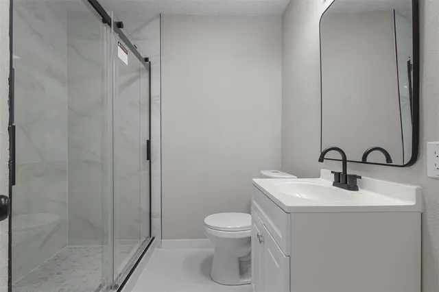 a bathroom with a toilet sink and shower