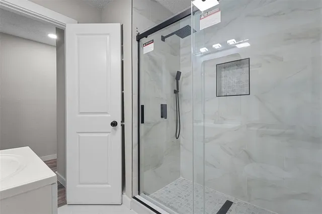 a bathroom with a shower and a glass door