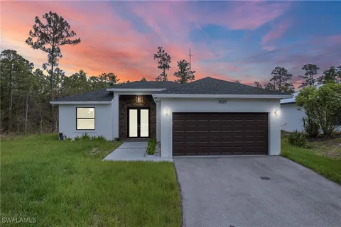 a front view of a house with a yard and garage