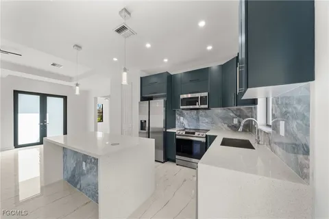 a kitchen with a sink stove and microwave