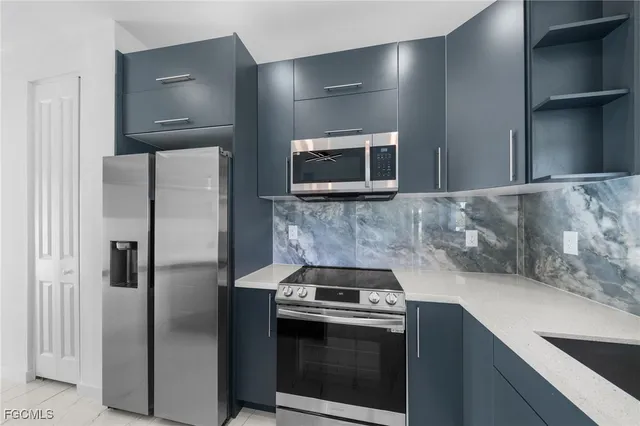 a kitchen with a sink stove and microwave