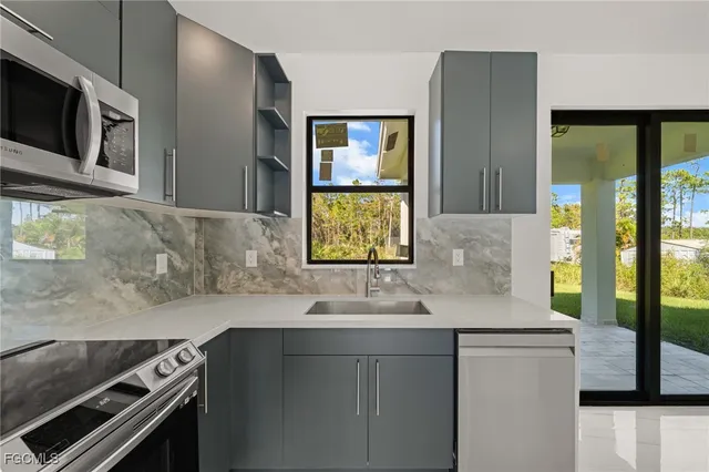 a kitchen with a sink and a refrigerator