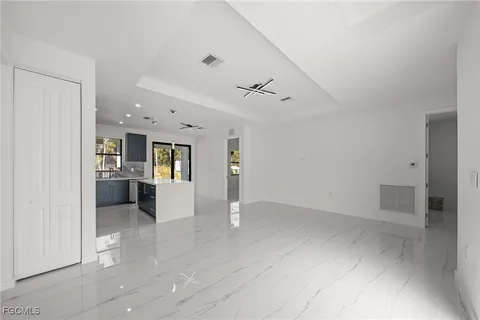 a view of kitchen with cabinets and window