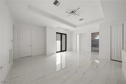 a living room with furniture and large windows