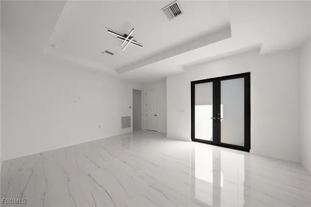 a living room with furniture and large windows