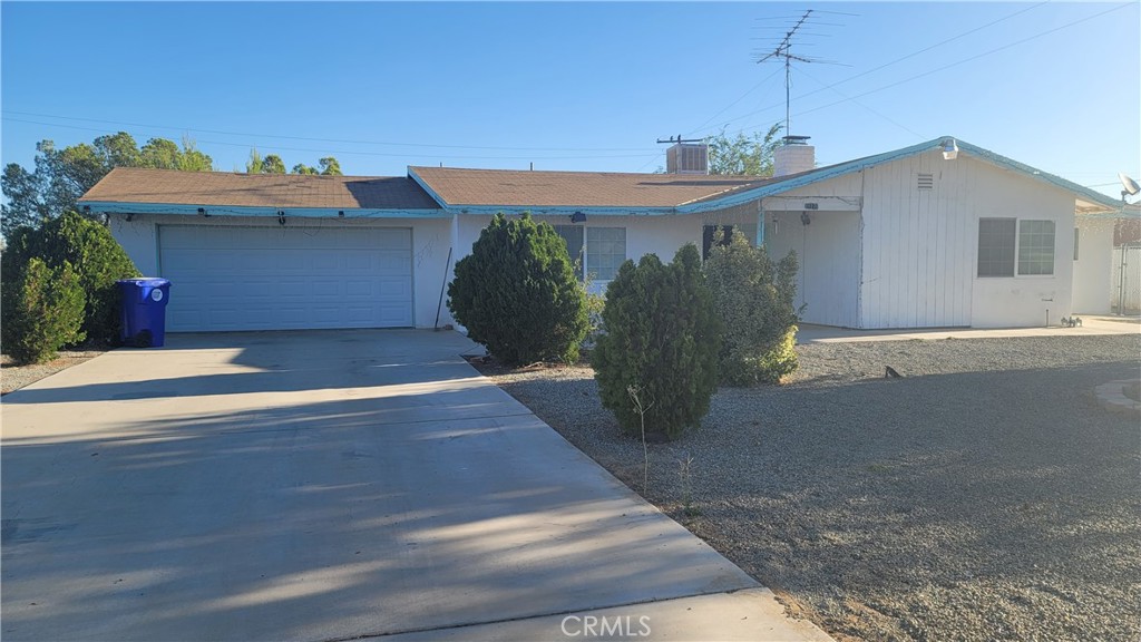 21170 Del Oro Road Apple Valley, CA 92308 - Photo 1 of 1 a front view of a house with a yard and garage