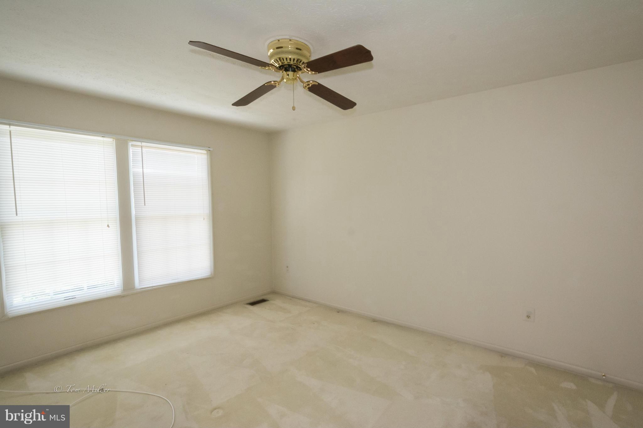 910 Metfield Road Baltimore, MD 21286 - Photo 15 of 22 an empty room with a window and a fan
