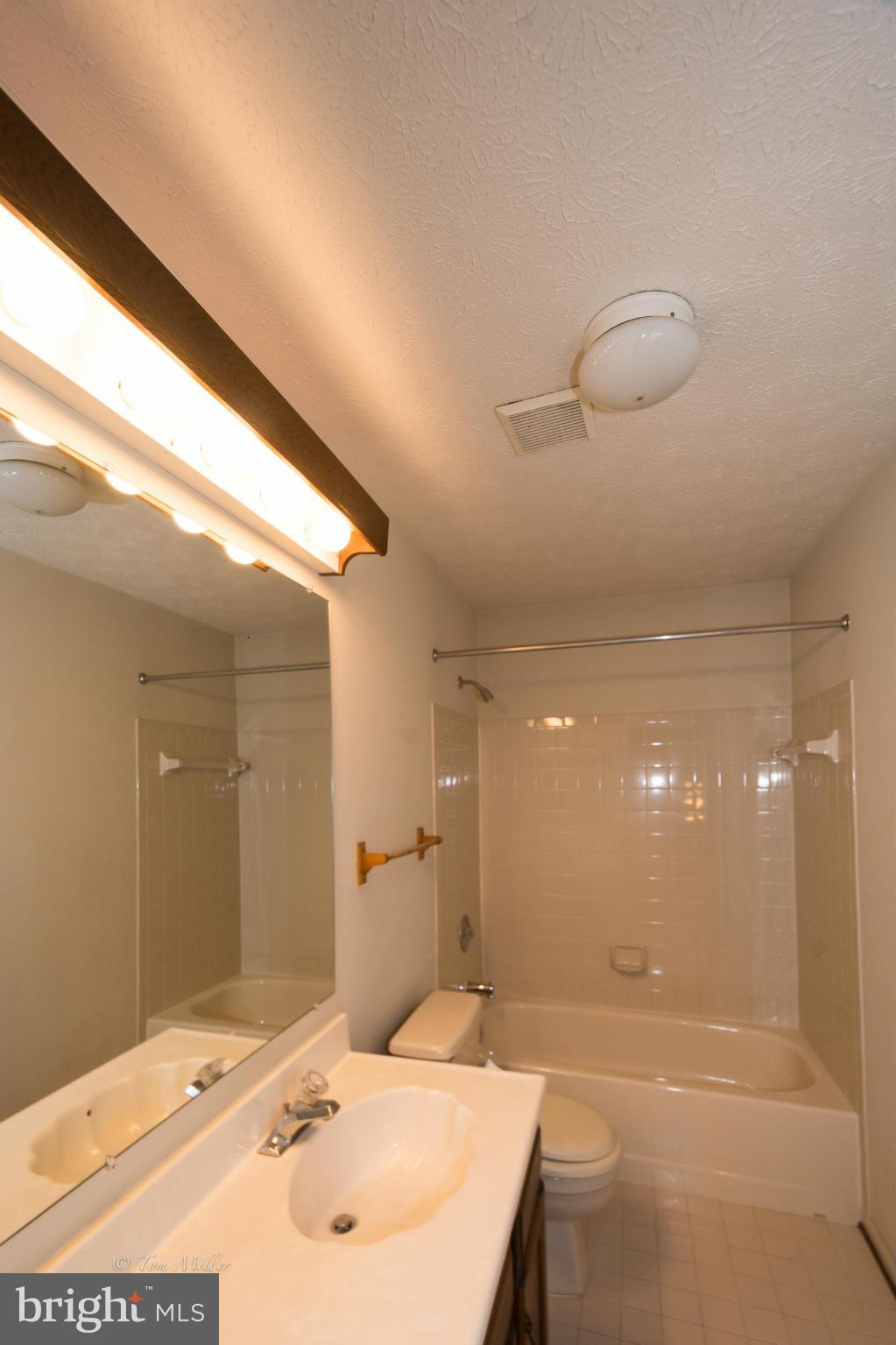 910 Metfield Road Baltimore, MD 21286 - Photo 20 of 22 a bathroom with a sink a large mirror and a shower