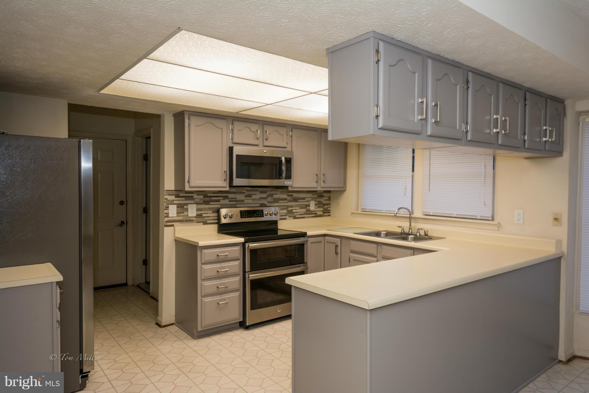 910 Metfield Road Baltimore, MD 21286 - Photo 5 of 22 a kitchen with stainless steel appliances granite countertop a sink stove and refrigerator