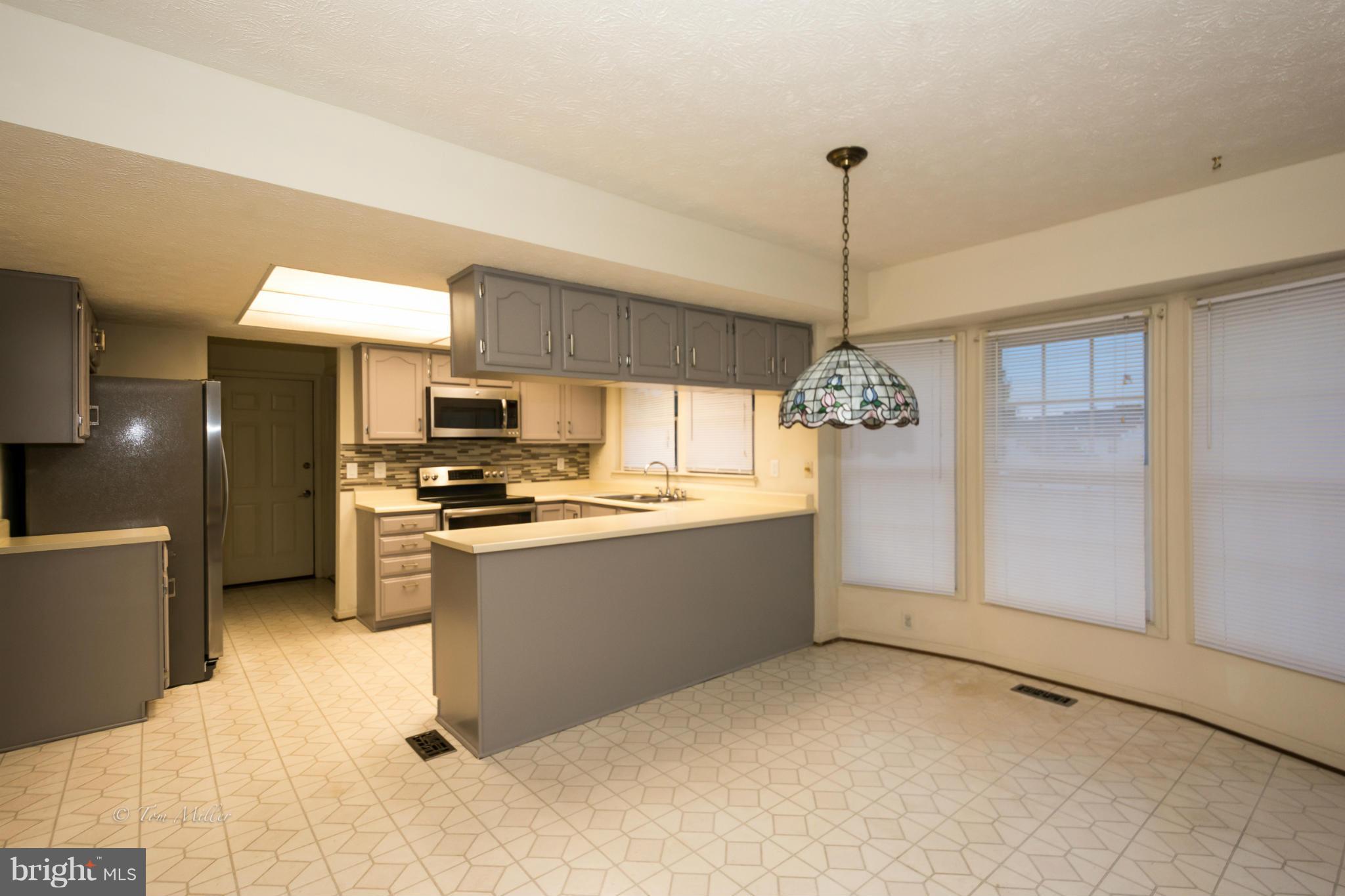 910 Metfield Road Baltimore, MD 21286 - Photo 6 of 22 a kitchen with refrigerator and window
