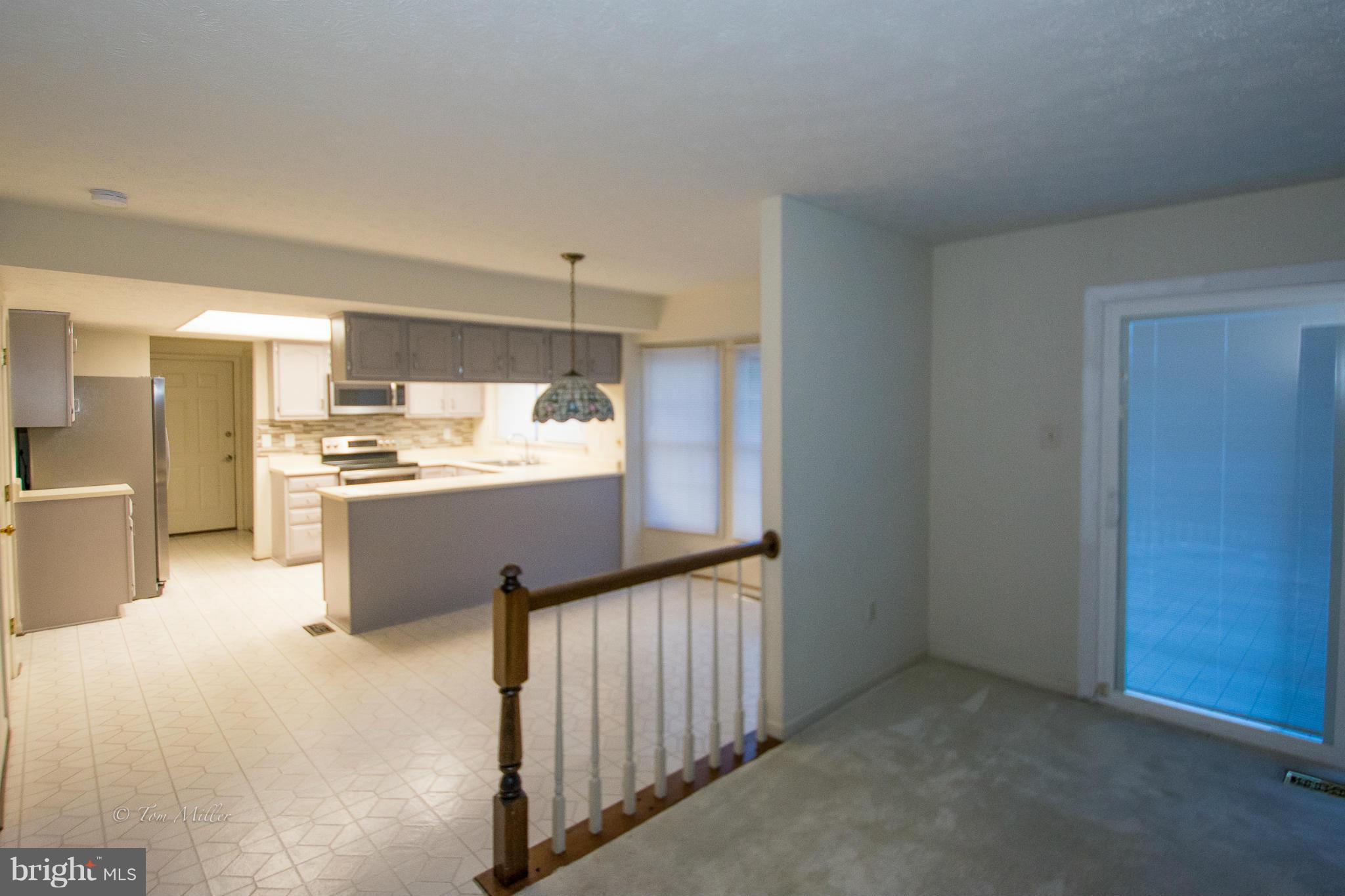 910 Metfield Road Baltimore, MD 21286 - Photo 7 of 22 a room with a bed and a refrigerator