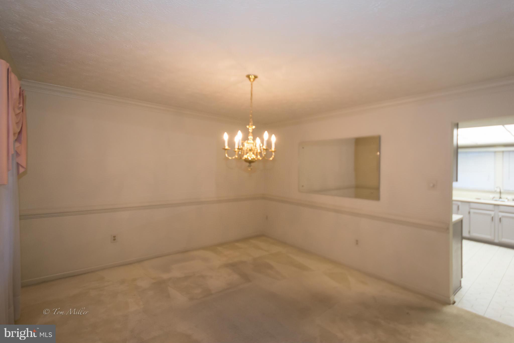910 Metfield Road Baltimore, MD 21286 - Photo 9 of 22 a view of a chandelier in big room and chandelier fan