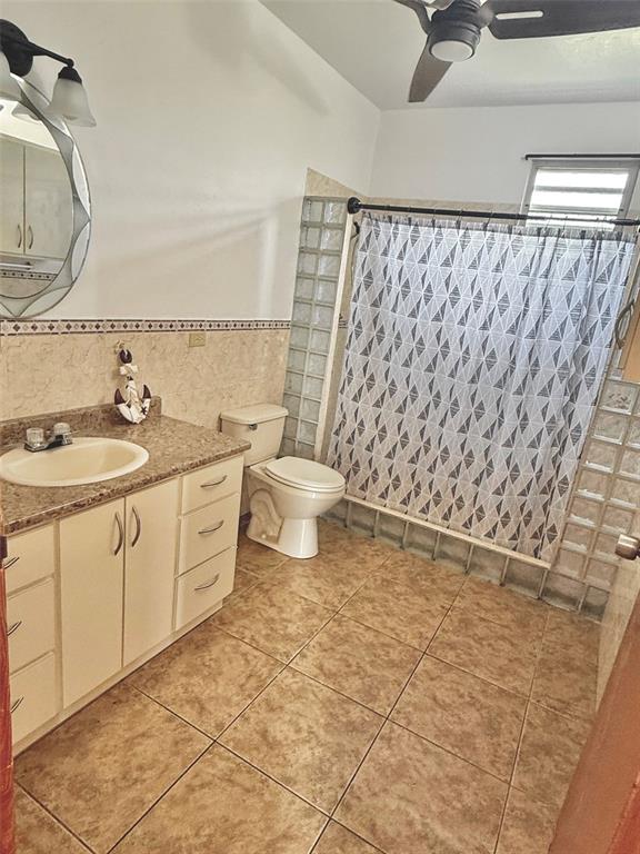 411 Bo Calvache Rincon, PR 00677 - Photo 8 of 14 a bathroom with a granite countertop sink a toilet and a mirror