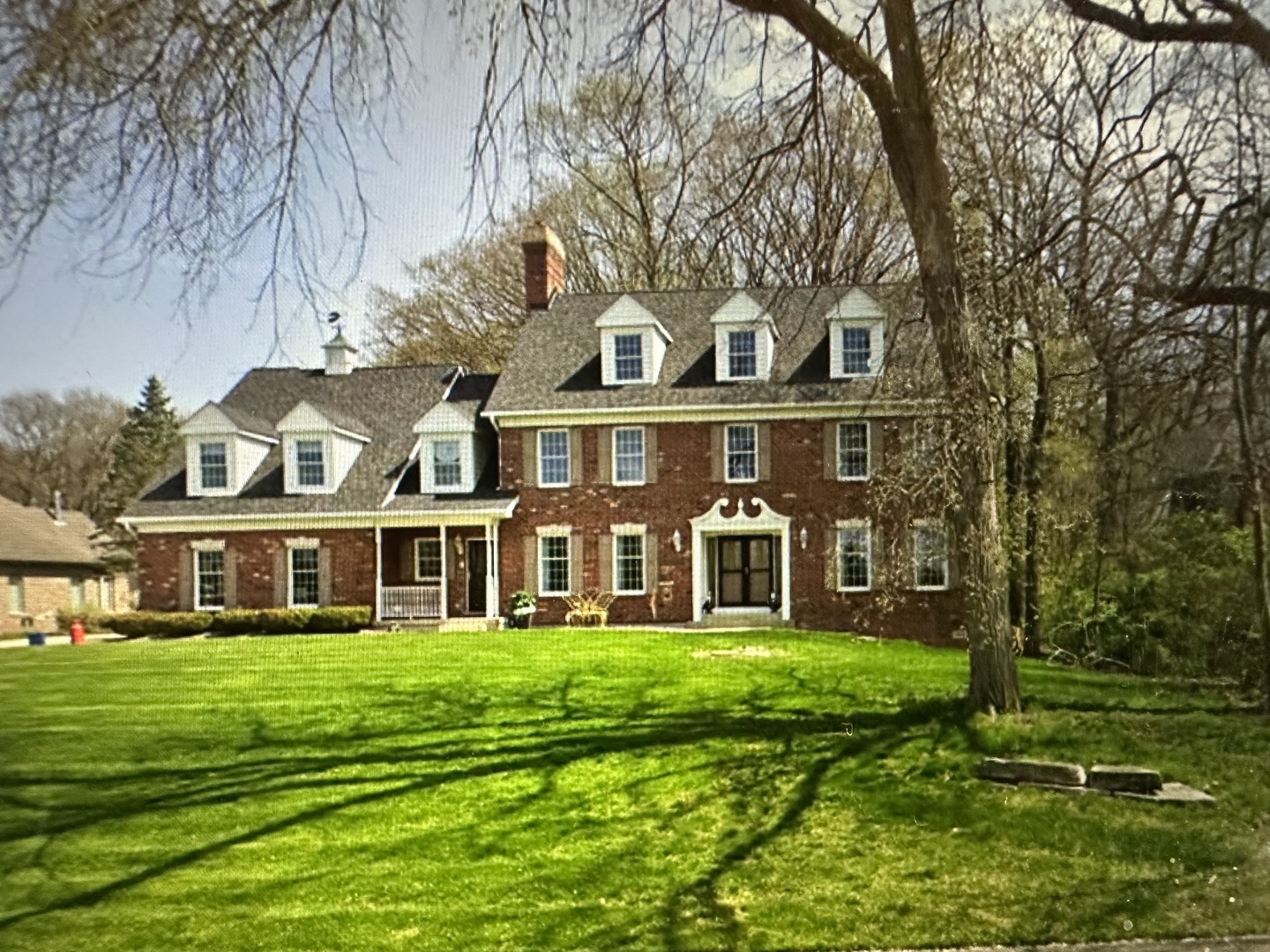 a front view of building with yard and green space