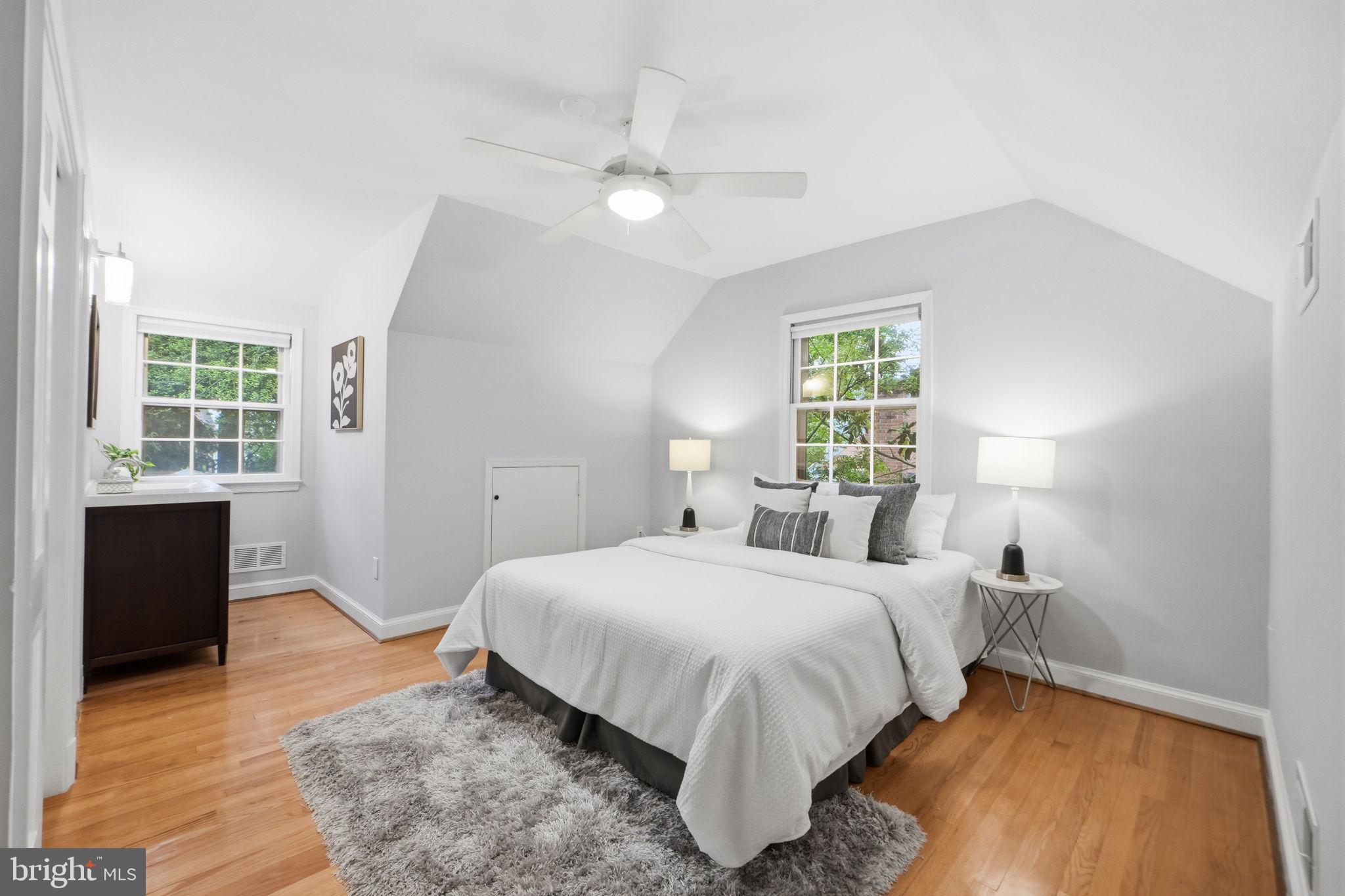 5910 Overlea Road Bethesda, MD 20816 - Photo 30 of 56 a bedroom with a bed and wooden floor
