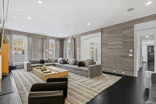 a very nice looking living room with a large window and furniture